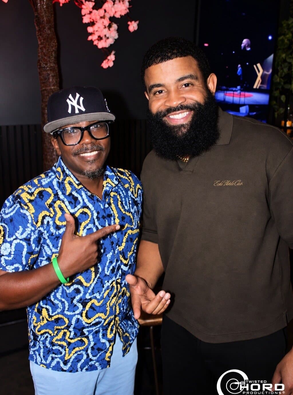 Two friends smiling at an evening event