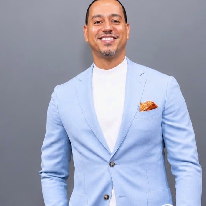 Studio portrait of a man in a light blue suit